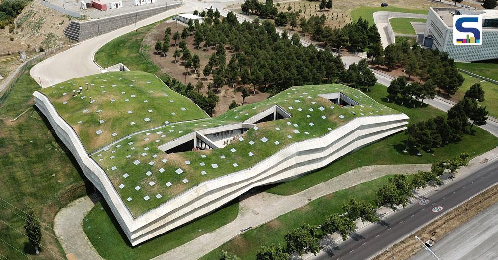 Concrete Facade and a Freen Roofs